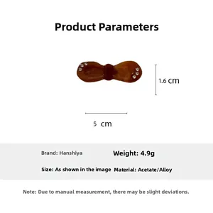 Detail view of acetic acid bow hair clip with white rhinestones and size measurements