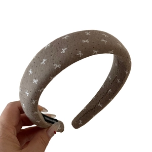 Maillard brown padded headband with white bow print and handmade label detail
