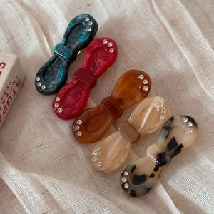 Set of five elegant acetate bow hair clips with rhinestones in various retro colors