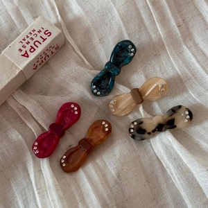 Five-piece set of acetate bow hair clips with rhinestones in marble and amber textures