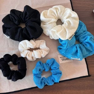 Détail montrant la texture en maille ajourée et les couleurs des chouchous élastiques