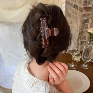 Elegant large tortoiseshell hair claw clip securing a sophisticated French updo hairstyle