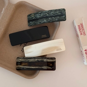 Set of four rectangle acetate hair clips in marbled green, black, cream and tortoiseshell