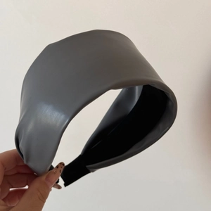 Detail of grey leather headband showing soft grain texture and comfortable black fabric inner