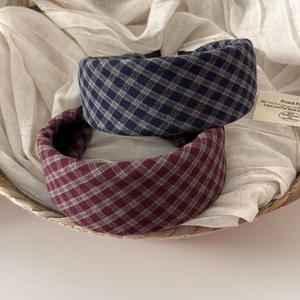 Detailed texture of thick sponge headbands with vintage blue and red plaid fabric patterns