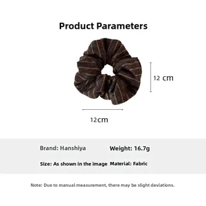 Detail view of a 12cm dark brown striped knit hair scrunchie with soft fabric texture