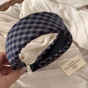 Detailed texture of thick plaid headband with vintage blue and grey woven fabric pattern