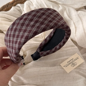 Close-up of thick wine red plaid headband showing premium textured checkered fabric
