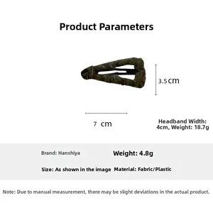 Detail showing fabric wrapped triangle hair clip dimensions 7cm by 3.5cm and 4.8g weight
