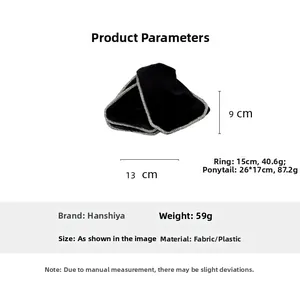 Detailed view of large black velvet bow hair claw clip with silver edge and size markings