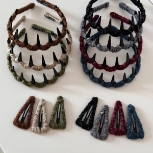 Detail of wool-wrapped spiked headband and matching clip with handmade woven label