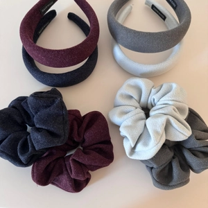 Detail view of velvet scrunchies and headbands set in navy, burgundy and grey tones