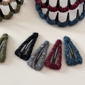 Detail view of colorful knitted wool wrapped BB hair clips and non-slip tooth headband