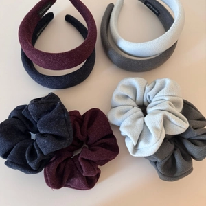 Close-up of assorted velvet scrunchies and matching wide sponge headbands in four colors
