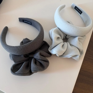 Detail view of velvet scrunchie and padded headband set with handmade label in grey