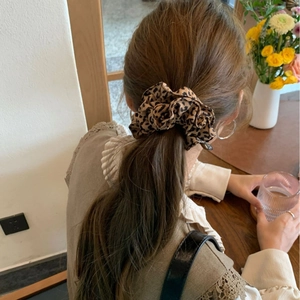 Vintage leopard print scrunchie for women, soft fabric hair tie on a low ponytail
