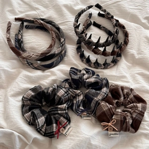 Detail view of plaid fabric headbands and hair scrunchies set with handmade labels