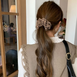 Classic leopard print hair scrunchie shown on high ponytail for elegant women styling