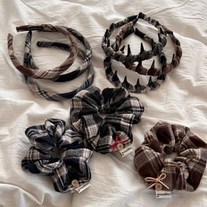 Detail of plaid fabric headbands and scrunchies featuring handmade wood buttons and bows