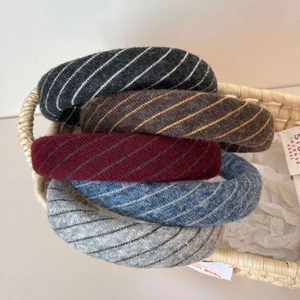 Set of five stylish diagonal knit hairbands in assorted colors displayed in a rustic basket