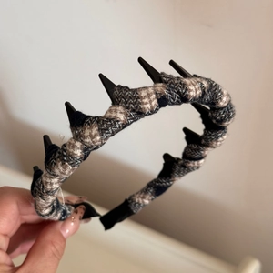 Macro view of checkered tweed fabric and non-slip inner teeth on this preppy headband