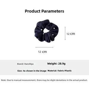 Navy blue knitted scrunchie with white pearl accents showing 12x12 cm dimensions