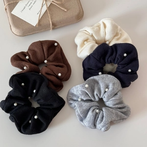 Five assorted knit scrunchies with white pearls in black, brown, cream, navy, and grey