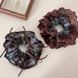 Detail view of retro blue and brown plaid scrunchie with lace and bow embellishments