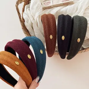 Wide knitted headband in six colors with gold metal label for autumn and winter fashion