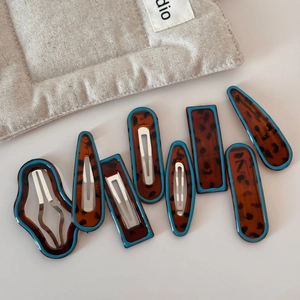 8-piece hair clip set featuring leopard print with blue edges and irregular geometry