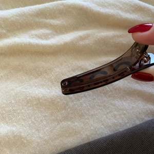 Close-up of translucent amber brown resin banana hair clip with non-slip inner teeth