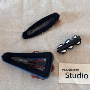 Detailed back view of navy polka dot hair clips set with secure black metal fasteners