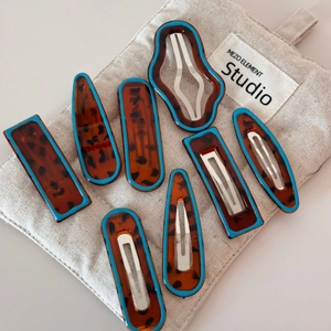 Set of 8 leopard print hair clips with blue edges in geometric and oval shapes