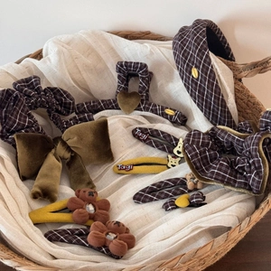 Brown plaid hair accessories set including bear clips and velvet bow on woven basket