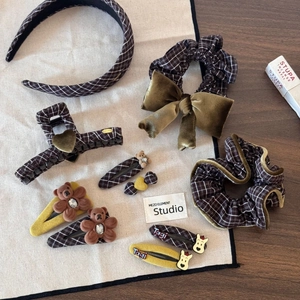 Flat lay of brown plaid hair accessories set featuring velvet bows and plush bears