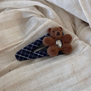 Detailed close-up of navy plaid BB hair clip featuring a cute flocked brown bear