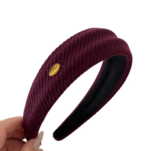 Wide burgundy ribbed knit headband with gold KOREA tag for high-top styling