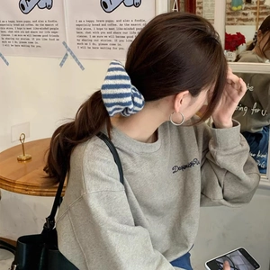 Oversized blue and white striped knitted scrunchie for women casual hair styling