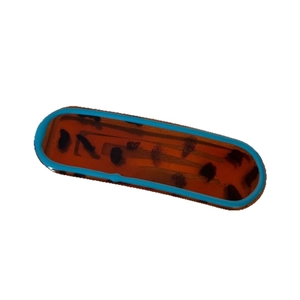 Blue-edged leopard print hair clip with irregular oval geometric shape in amber resin
