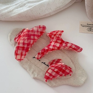 Three-piece set of red and white plaid acetate hair claws in various sizes and shapes