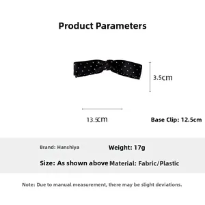 Detailed view of large black polka dot bow banana hair clip with 12.5cm size base