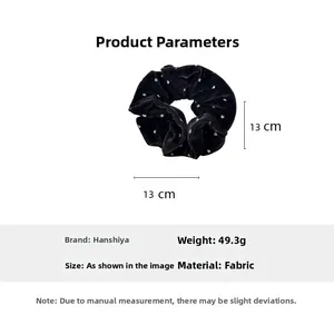 Detail view of a 13cm black velvet scrunchie with white heart pattern and weight specs