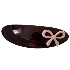 Brown oval acetate hair clip with pink bow and sparkling diamond center ornament