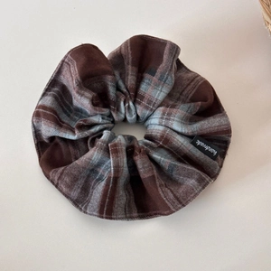 Détail d'un chouchou géant à carreaux avec étiquette fait main en tissu doux