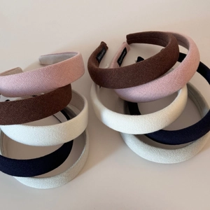 Collection of textured knit sponge headbands in various colors with handmade label