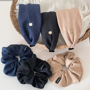 Detail showing knitted texture stripe scrunchies and headbands with handmade labels