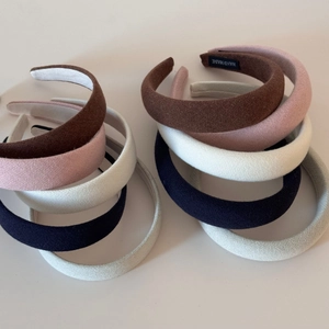 Detailed macro view of high-crown padded headbands with soft knitted fabric texture