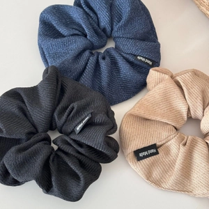 Three-piece set of large striped fabric scrunchies in navy, black and beige colors