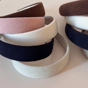 Padded knit headbands in brown, pink, and white for a high-volume hair look