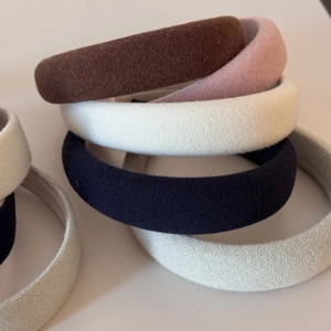 Close-up of thick padded sponge headbands with various knitted fabric texture and colors